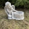 Angel with vase sculpture